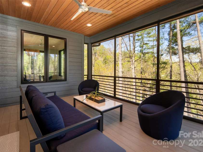42 Spring Cove Road, Asheville, NC 28804.  MLS# CAR4246585, YatesRealty ID 13759. Outdoor covered and screened porch on main level overlooks lushly landscaped yard, mature trees and amazing winter mountain views.