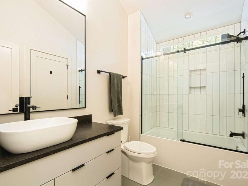 42 Spring Cove Road, Asheville, NC 28804.  MLS# CAR4246585, YatesRealty ID 13759. Second full bath on second floor features vanity with vessel sink and shower & tub combo.