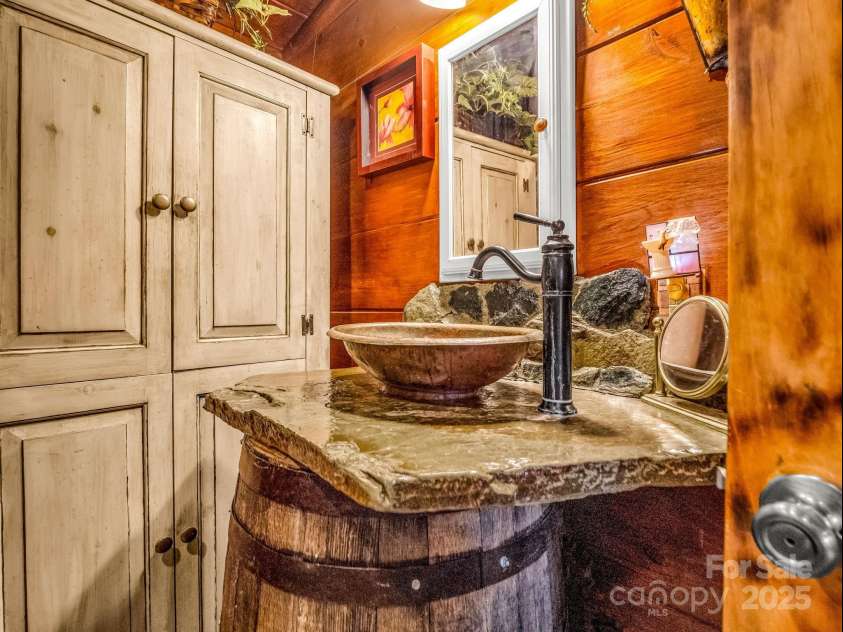 1002 CC Road, Rutherfordton, NC 28139.  MLS# CAR4249234, YatesRealty ID 13761. Full bathroom in the guest cabin also has custom stonework.