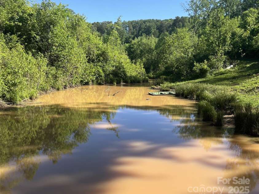 1002 CC Road, Rutherfordton, NC 28139.  MLS# CAR4249234, YatesRealty ID 13761. Spring fed pond is stocked with fish.