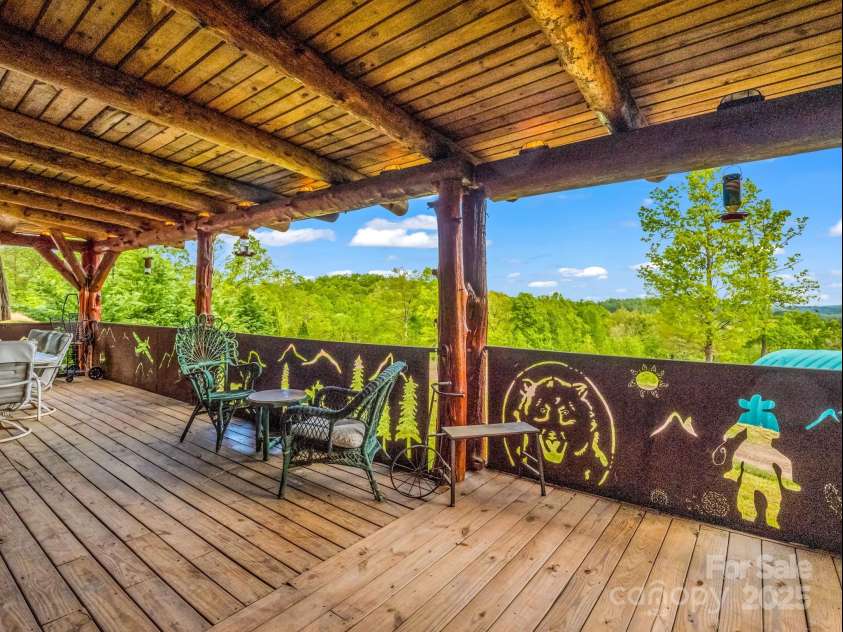 1002 CC Road, Rutherfordton, NC 28139.  MLS# CAR4249234, YatesRealty ID 13761. Three-sided, covered wrap around porch with steel railings.