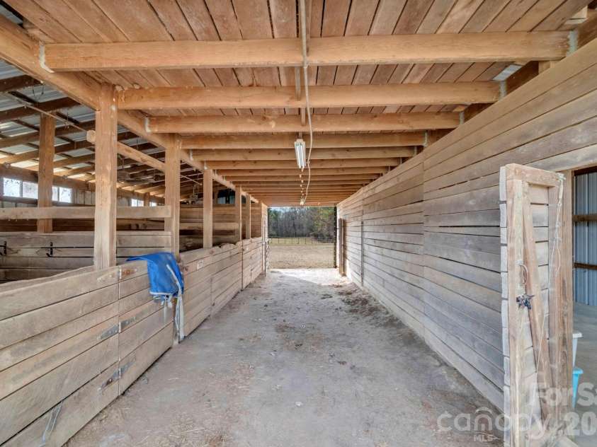 7812 Hwy 742 Highway, Marshville, NC 28103.  MLS# CAR4383299, YatesRealty ID 13761. 3 12'x12' stalls, tack room with bridal hooks, & feed room