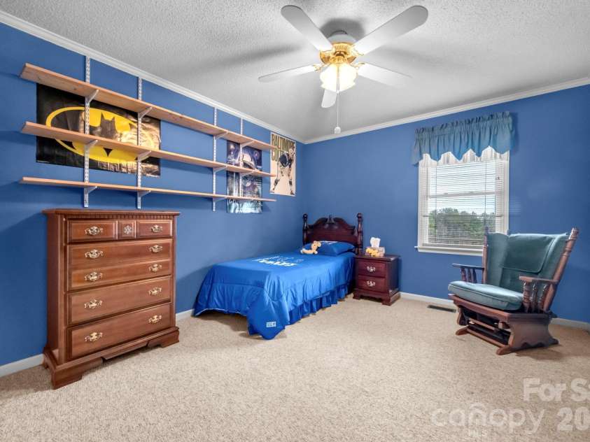 7812 Hwy 742 Highway, Marshville, NC 28103.  MLS# CAR4383299, YatesRealty ID 13761. Guest bedroom with ceiling fan and large walk-in closet