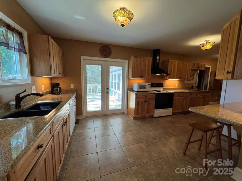 66 Arlington Avenue, Concord, NC 28025.  MLS# CAR4256759, YatesRealty ID 13780. Kitchen with french doors leading to the deck
