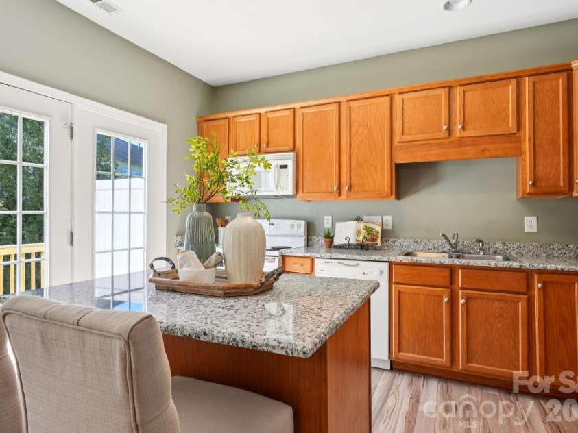 209 Township Drive, Fort Mill, SC 29715.  MLS# CAR4356520, YatesRealty ID 13788. Kitchen Leading to Backyard Patio