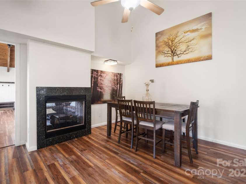 158 Blackberry Lane, Maggie Valley, NC 28751.  MLS# CAR4242897, YatesRealty ID 138. Dining Area and see through gas fireplace