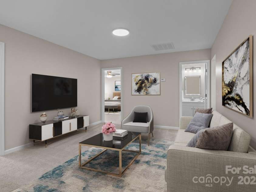 302 Flanders Drive, Mooresville, NC 28117.  MLS# CAR4230746, YatesRealty ID 13806. Virtually staged to showcase a warm and inviting loft area, perfect for sitting, reading, or enjoying movies and a cozy den space.