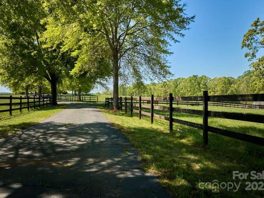 820 Phillips Road, Columbus, NC 28722.  MLS# CAR4250822, YatesRealty ID 13808. Tree and fence-lined driveway