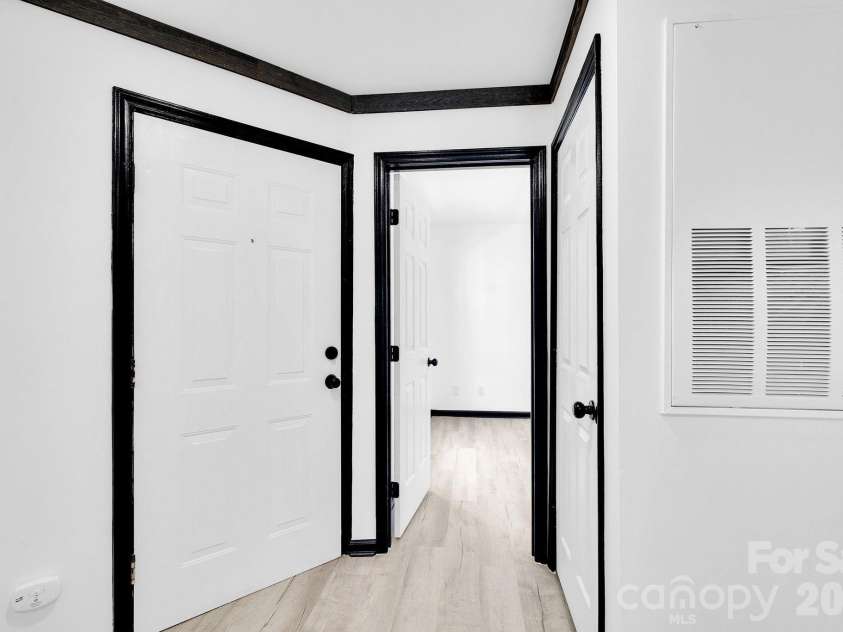 18755 Vineyard Point Lane, Cornelius, NC 28031.  MLS# CAR4371639, YatesRealty ID 13827. Front Door to Condo, Looking into Secondary Bedroom