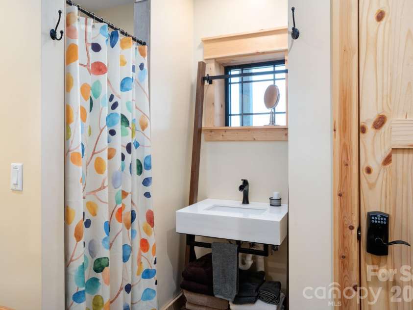 55 Laurel Ridge, Marshall, NC 28753.  MLS# CAR4353005, YatesRealty ID 13833. Tiled shower, single sink and owners storage closet