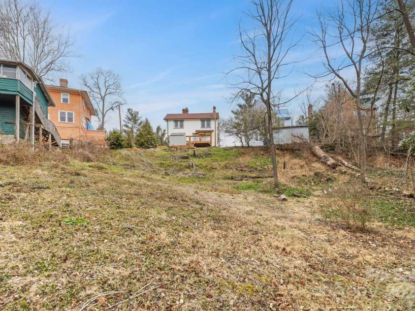 41 Forest Hill Drive, Asheville, NC 28803.  MLS# CAR4217296, YatesRealty ID 13843. Backyard looking up at home