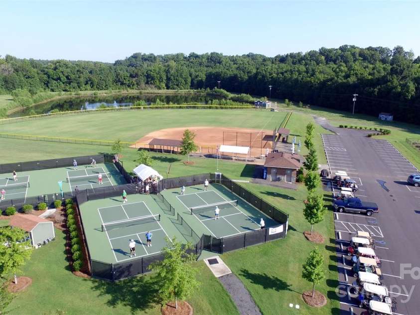 10432 Bethpage Drive, Indian Land, SC 29707.  MLS# CAR4235926, YatesRealty ID 13863. Water's Edge Park, located near the Catawba River, is home to pickleball, horseshoes, softball, fishing, frisbee golf, and a model airplane airstrip. It is also home to one of two community gardens. A walk on the pa