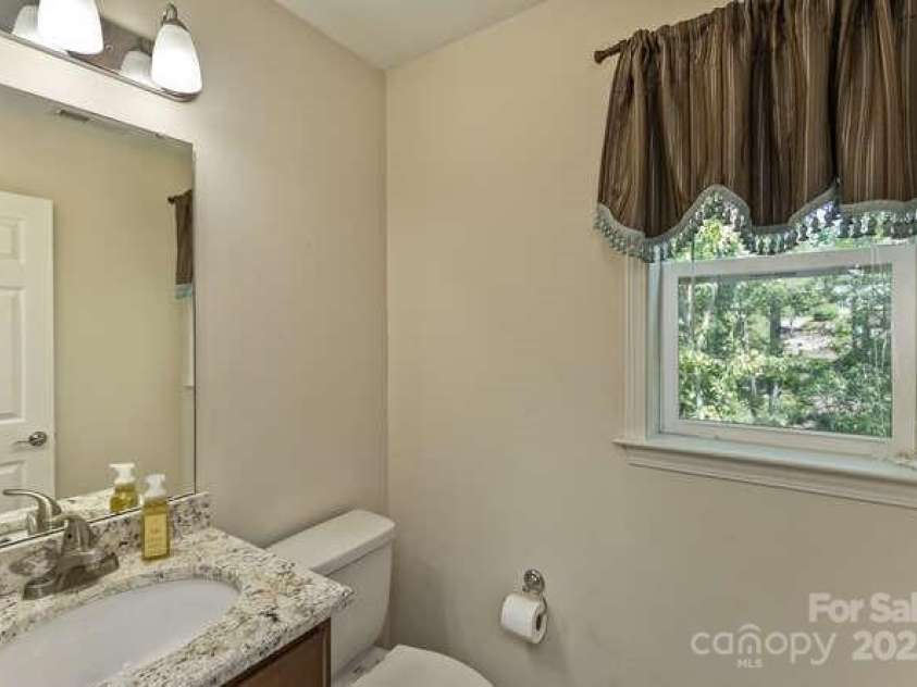 43 Sunny Meadows Boulevard, Arden, NC 28704.  MLS# CAR4249909, YatesRealty ID 13867. Half bathroom near the kitchen with natural stone vanity top