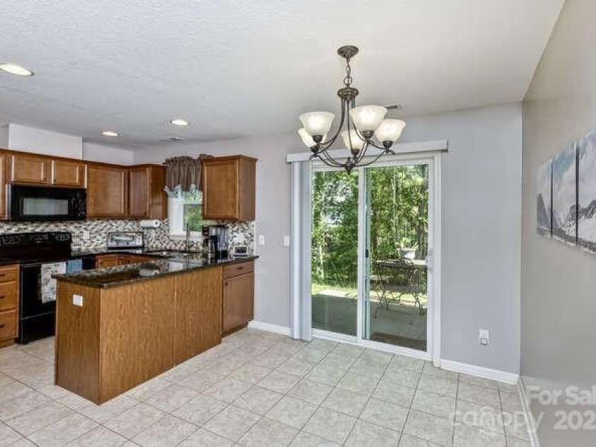 43 Sunny Meadows Boulevard, Arden, NC 28704.  MLS# CAR4249909, YatesRealty ID 13867. Neutral tile flooring in kitchen and dining room