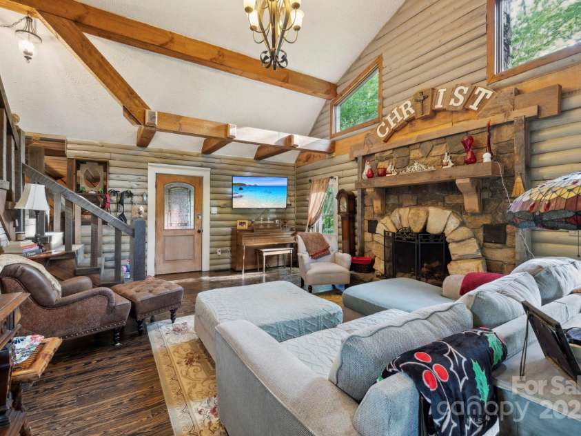 214 Hubert Mccall Road, Balsam Grove, NC 28708.  MLS# CAR4256871, YatesRealty ID 13872. Living Room with Vaulted Ceiling and Stone Fireplace