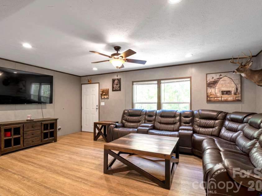 87 Horseback Lane, Marshall, NC 28753.  MLS# CAR4363036, YatesRealty ID 13882. Light-filled living room with plenty of room to gather