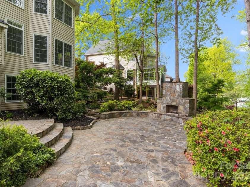 263 Fernbrook Drive, Mooresville, NC 28117.  MLS# CAR4246852, YatesRealty ID 13887. Awesome lake facing stone patio and fireplace to enjoy stunning sunsets.