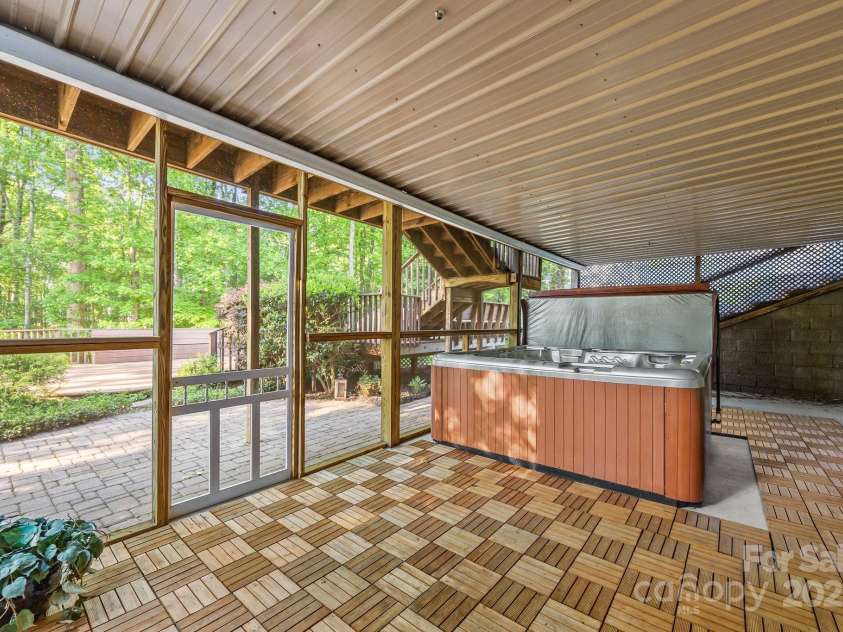 263 Fernbrook Drive, Mooresville, NC 28117.  MLS# CAR4246852, YatesRealty ID 13887. Enjoy the 6-person hot tub on the private screened-in porch with access to the lower level.