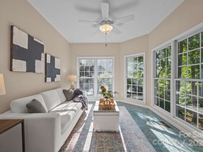 263 Fernbrook Drive, Mooresville, NC 28117.  MLS# CAR4246852, YatesRealty ID 13887. Light-filled lake-facing sunroom on main level.