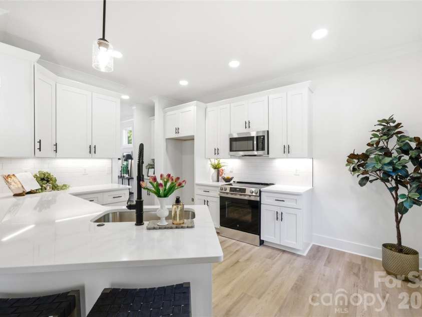 356 Main Street, McAdenville, NC 28101.  MLS# CAR4315707, YatesRealty ID 1389. A welcoming breakfast bar paired with stylish pendant lighting creates the perfect setting for casual dining and everyday gathering