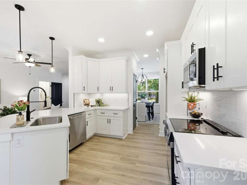 356 Main Street, McAdenville, NC 28101.  MLS# CAR4315707, YatesRealty ID 1389. Bright, beautifully designed, and made for gathering — this chef-inspired kitchen features quartz countertops, abundant cabinetry, under-cabinet lighting, and seamless flow into the living and dining spaces for effortless