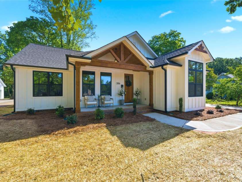356 Main Street, McAdenville, NC 28101.  MLS# CAR4315707, YatesRealty ID 1389. Modern farmhouse charm meets timeless small-town living in the heart of McAdenville. Featuring striking timber accents, black windows, an inviting covered front porch, and beautiful architectural details, this move-in-rea