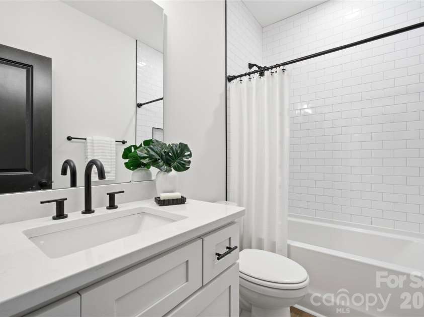 356 Main Street, McAdenville, NC 28101.  MLS# CAR4315707, YatesRealty ID 1389. Timeless finishes and thoughtful details shine in the shared bath, featuring white subway tile, matte black fixtures, and quartz countertops