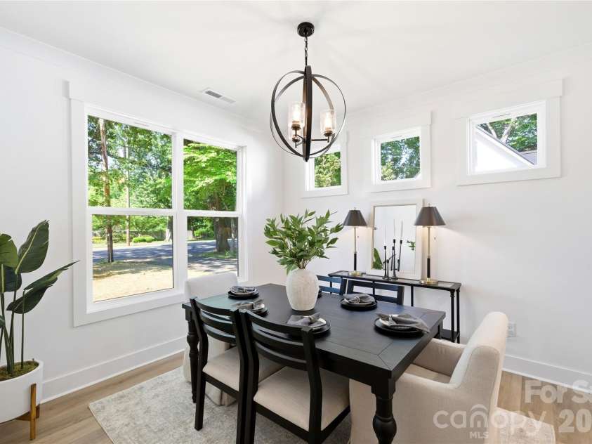 356 Main Street, McAdenville, NC 28101.  MLS# CAR4315707, YatesRealty ID 1389. Windows flood the dining room with natural light, while the statement light fixture adds warmth and architectural character