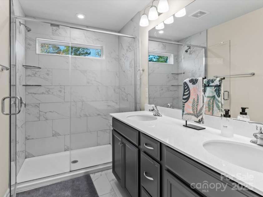 18014 Pear Hawthorne Drive, Huntersville, NC 28078.  MLS# CAR4198859, YatesRealty ID 13899. Luxurious bathroom with tiled super shower, quartz countertops with dual vanities