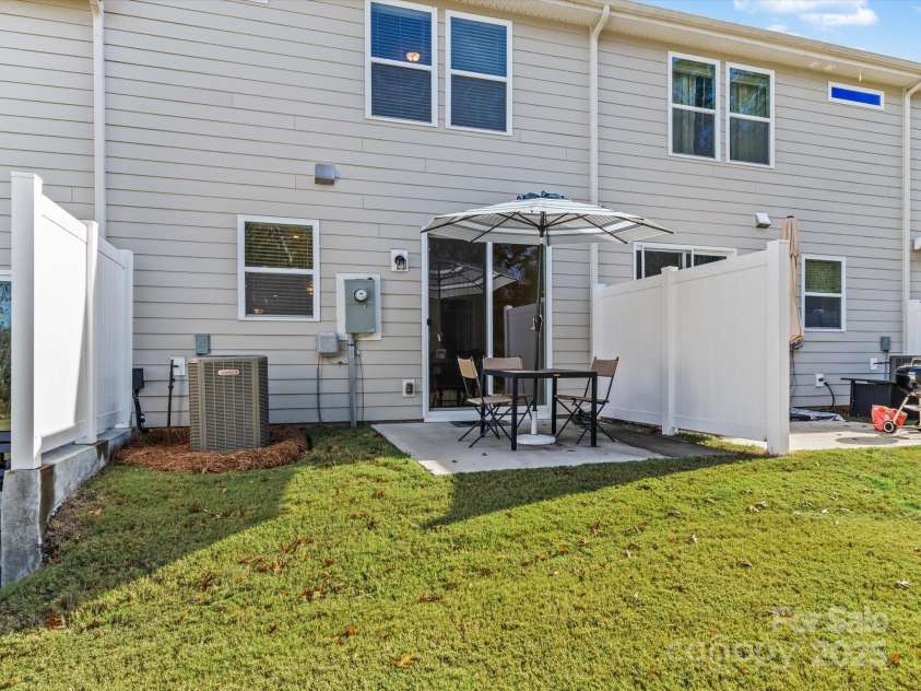 18014 Pear Hawthorne Drive, Huntersville, NC 28078.  MLS# CAR4198859, YatesRealty ID 13899. View of patio and side fencing for privacy.