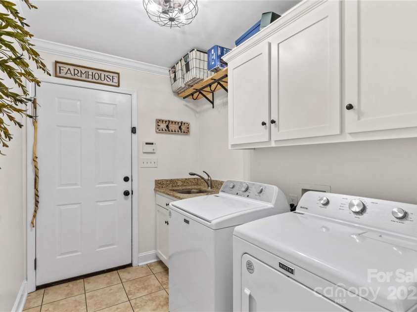4336 Hunter Rhyne Road, Lincolnton, NC 28092.  MLS# CAR4257970, YatesRealty ID 13917. Laundry room with cabinets, s/s sink, and hanging rack