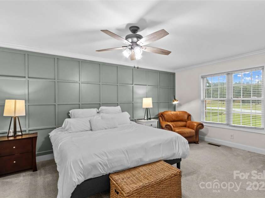 4336 Hunter Rhyne Road, Lincolnton, NC 28092.  MLS# CAR4257970, YatesRealty ID 13917. Primary Bedroom with ceiling fan, carpet, accent wall, crown molding and dual closets