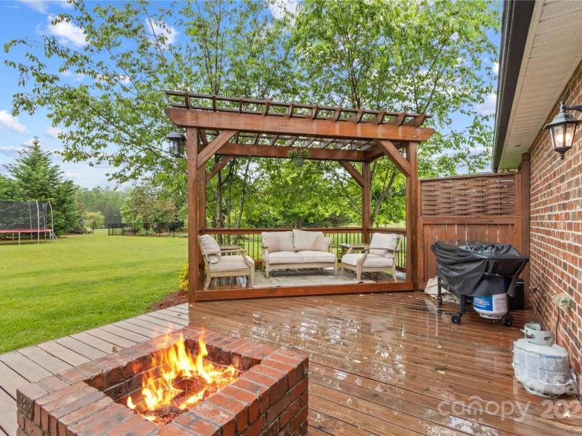 4336 Hunter Rhyne Road, Lincolnton, NC 28092.  MLS# CAR4257970, YatesRealty ID 13917. Rear Dec with fire pit, pergola sitting area