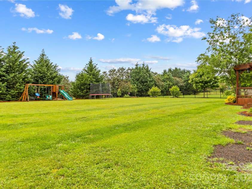 4336 Hunter Rhyne Road, Lincolnton, NC 28092.  MLS# CAR4257970, YatesRealty ID 13917. Rear yard (to tree line)  Playground equipment conveys