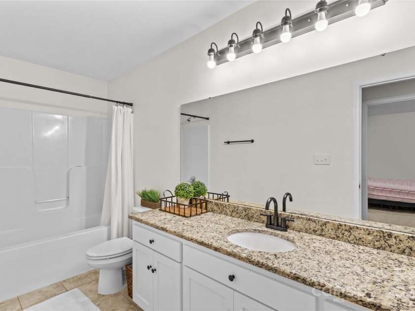 4336 Hunter Rhyne Road, Lincolnton, NC 28092.  MLS# CAR4257970, YatesRealty ID 13917. Secondary bath with granite counter top, tile floors and tub surround