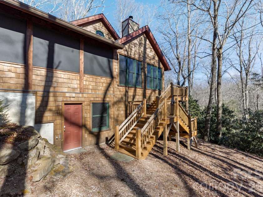 451 Crescent Trail, Highlands, NC 28741.  MLS# CAR4342214, YatesRealty ID 1392. Side Elevation (Entrances to both storage room and Bonus Room)