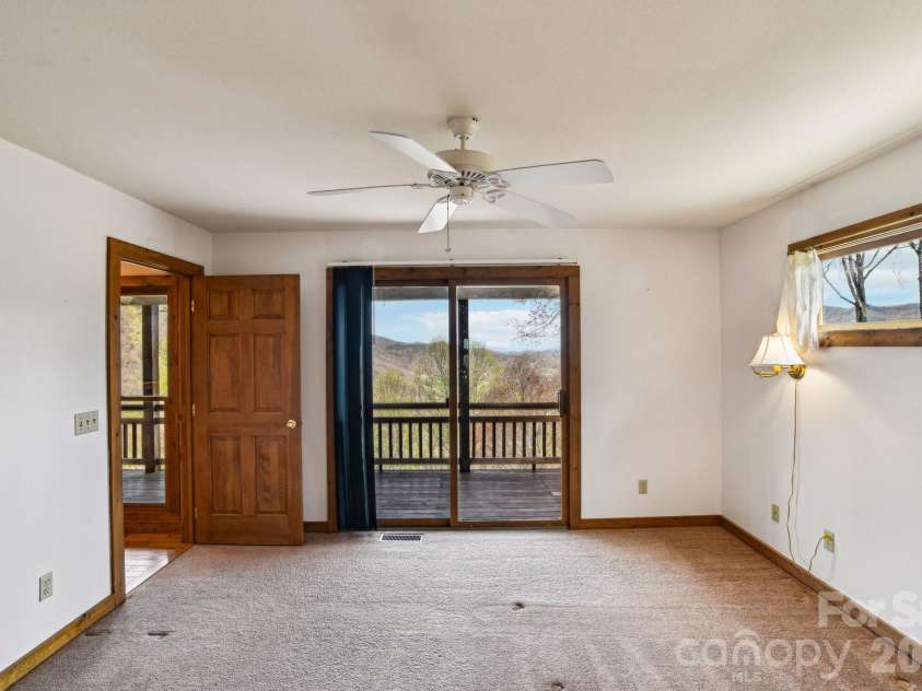 1426 Setzer Cove Road, Maggie Valley, NC 28751.  MLS# CAR4249259, YatesRealty ID 13972. Access the upper covered deck from the guest room