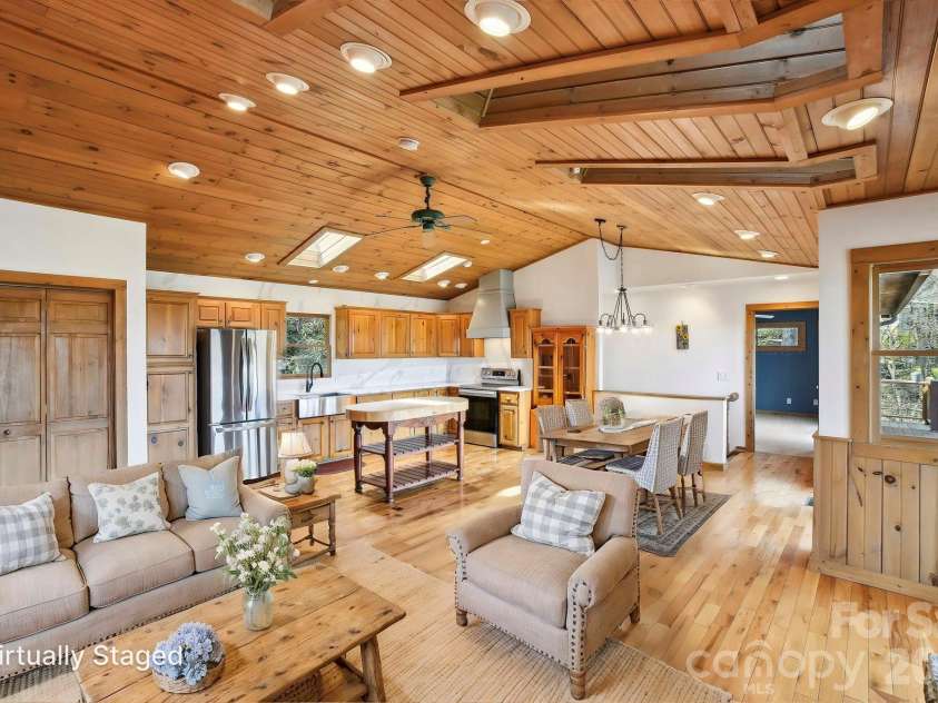 1426 Setzer Cove Road, Maggie Valley, NC 28751.  MLS# CAR4249259, YatesRealty ID 13972. Virtually staged great room