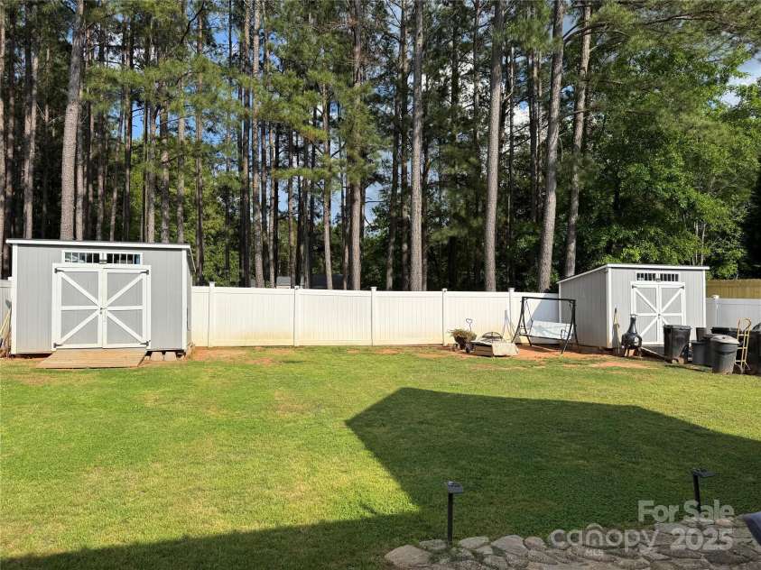 311 Masters Drive, Rock Hill, SC 29732.  MLS# CAR4252874, YatesRealty ID 13984. Backyard with 3 sheds