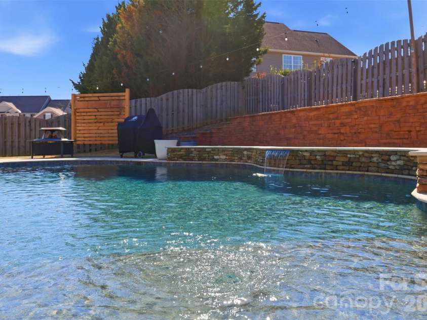 6004 Brook Valley Run, Monroe, NC 28110.  MLS# CAR4344182, YatesRealty ID 13984. Bubbler, waterfall, retaining wall