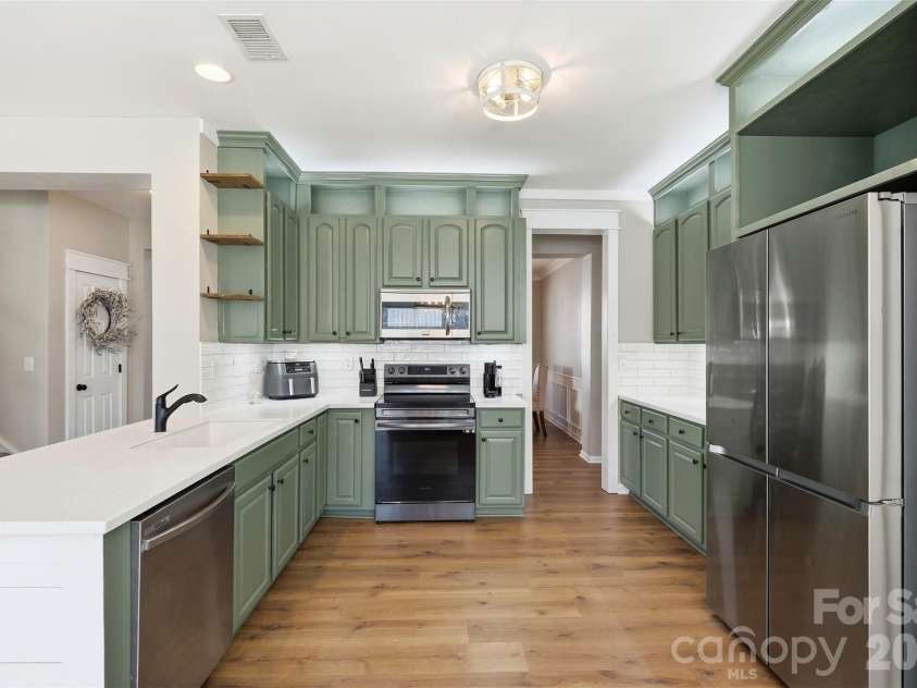 6004 Brook Valley Run, Monroe, NC 28110.  MLS# CAR4344182, YatesRealty ID 13984. Kitchen- custom quartz countertops, custom lighting & shiplap accents, & thoughtfully painted cabinets