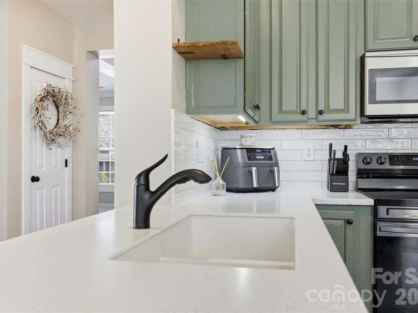 6004 Brook Valley Run, Monroe, NC 28110.  MLS# CAR4344182, YatesRealty ID 13984. Kitchen- custom quartz countertops, custom lighting & shiplap accents, & thoughtfully painted cabinets