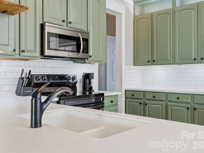 6004 Brook Valley Run, Monroe, NC 28110.  MLS# CAR4344182, YatesRealty ID 13984. Kitchen- custom quartz countertops, custom lighting & shiplap accents, & thoughtfully painted cabinets
