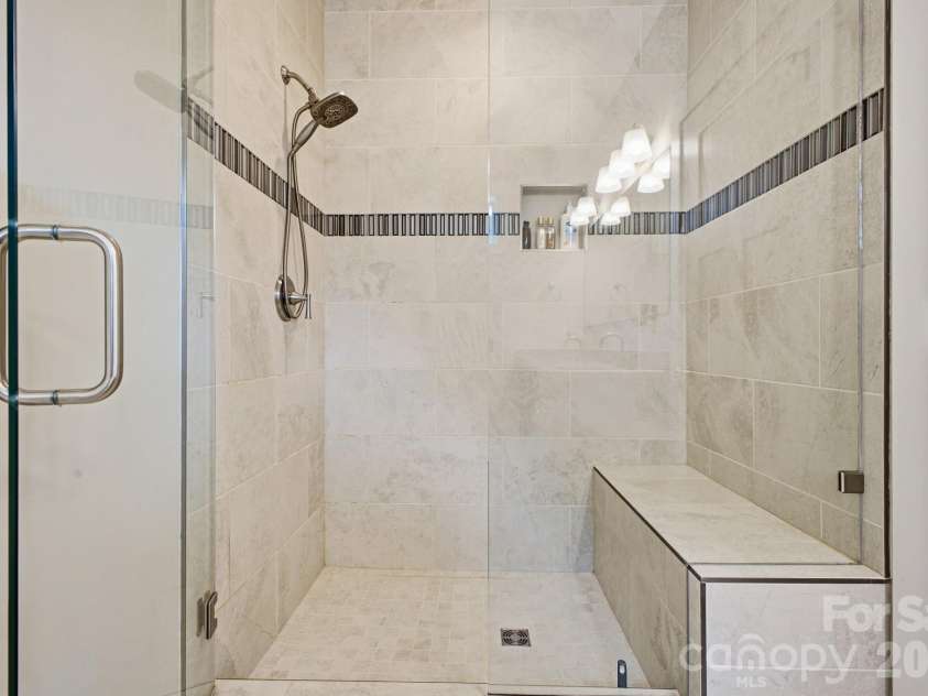 2 Lifestyle Court, Arden, NC 28704.  MLS# CAR4360396, YatesRealty ID 13985. Low profile entry shower with bench seating