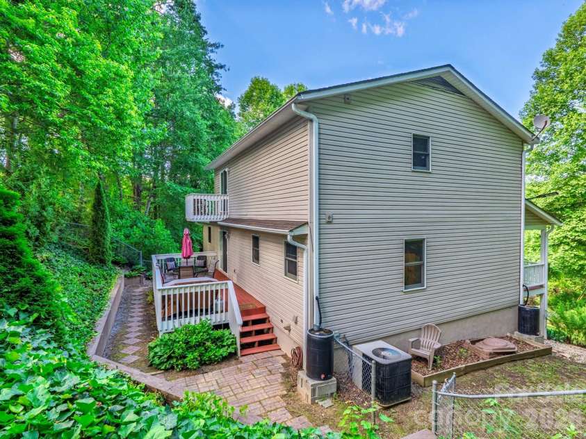 26 Morrow Drive, Fairview, NC 28730.  MLS# CAR4349703, YatesRealty ID 13987. Access the backyard from the kitchen sliding doors, the driveway, or the front yard