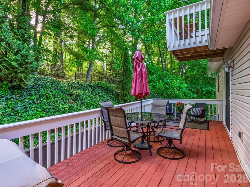 26 Morrow Drive, Fairview, NC 28730.  MLS# CAR4349703, YatesRealty ID 13987. Enjoy dining and entertaining outside surrounded by the trees on your large deck