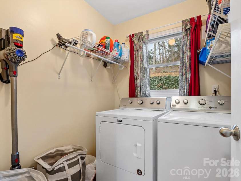 26 Morrow Drive, Fairview, NC 28730.  MLS# CAR4349703, YatesRealty ID 13987. Laundry room on the main level next to the kitchen