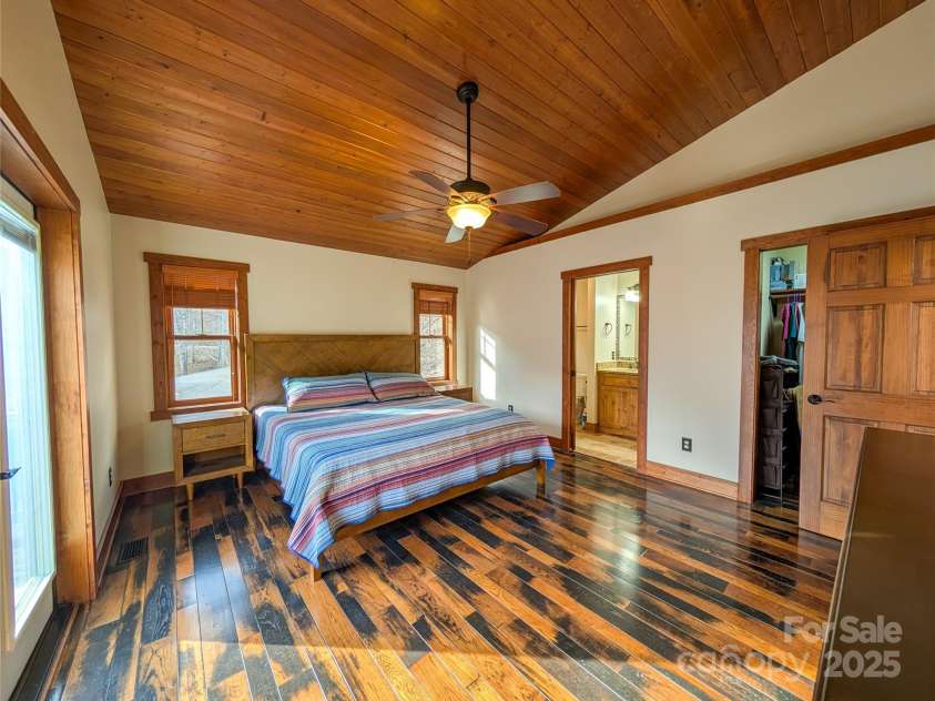 13 Miners Trace Road, Burnsville, NC 28714.  MLS# CAR4206928, YatesRealty ID 13994. Additional view of primary bedroom showing entrance to bathroom & walk-in closet.
