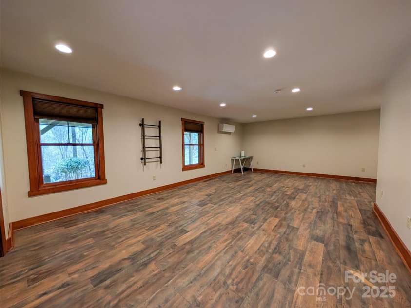 13 Miners Trace Road, Burnsville, NC 28714.  MLS# CAR4206928, YatesRealty ID 13994. Beyond the main living space, the fully finished basement, accessible from an exterior entrance, provides versatile additional living space, complete with a full bathroom – perfect for guests or as a private retreat.