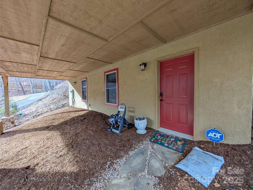 13 Miners Trace Road, Burnsville, NC 28714.  MLS# CAR4206928, YatesRealty ID 13994. Entrance to Fully finished basement with additional living space. (additional living space is not accessible from main level. Access is below near parking)